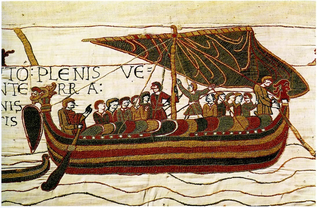 Ships and figures embroidered in a scene from the Bayeux Tapestry
